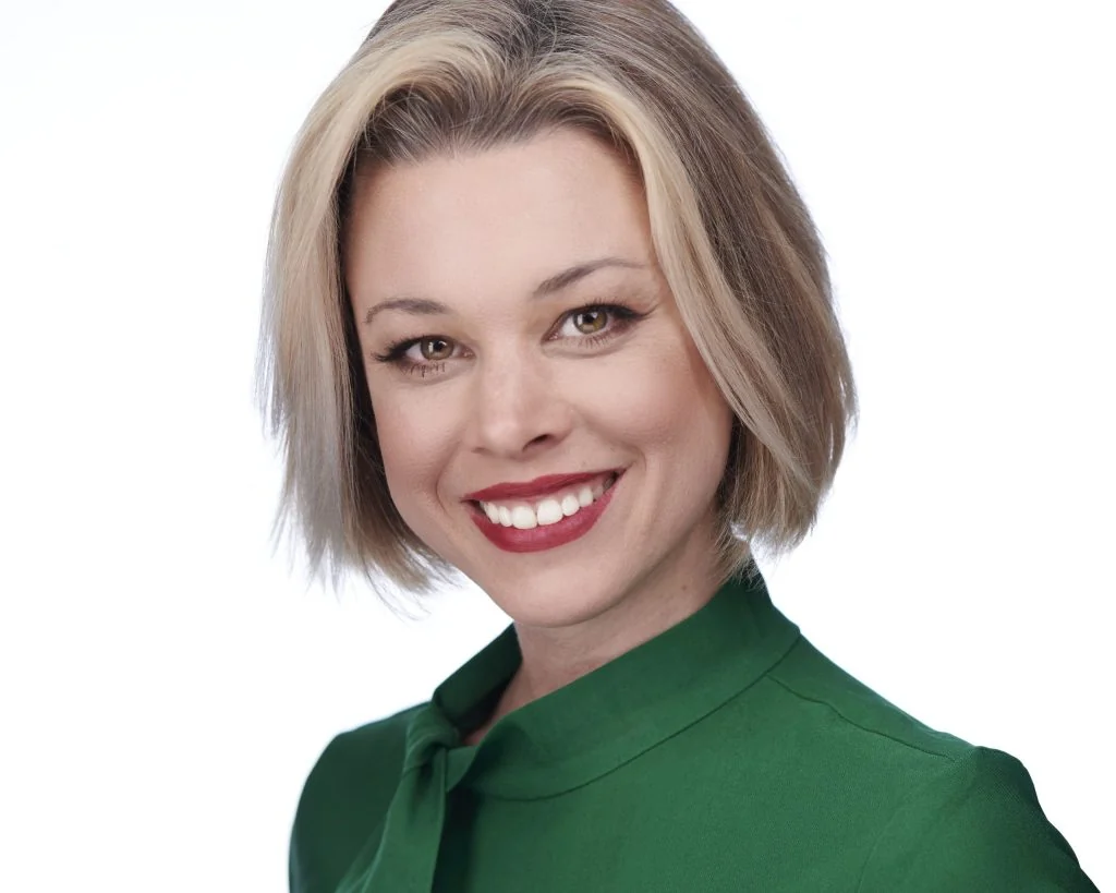 Business headshot of a woman in a green blouse