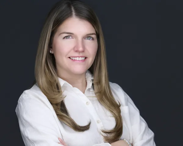 Senior leadership headshot with composed expression